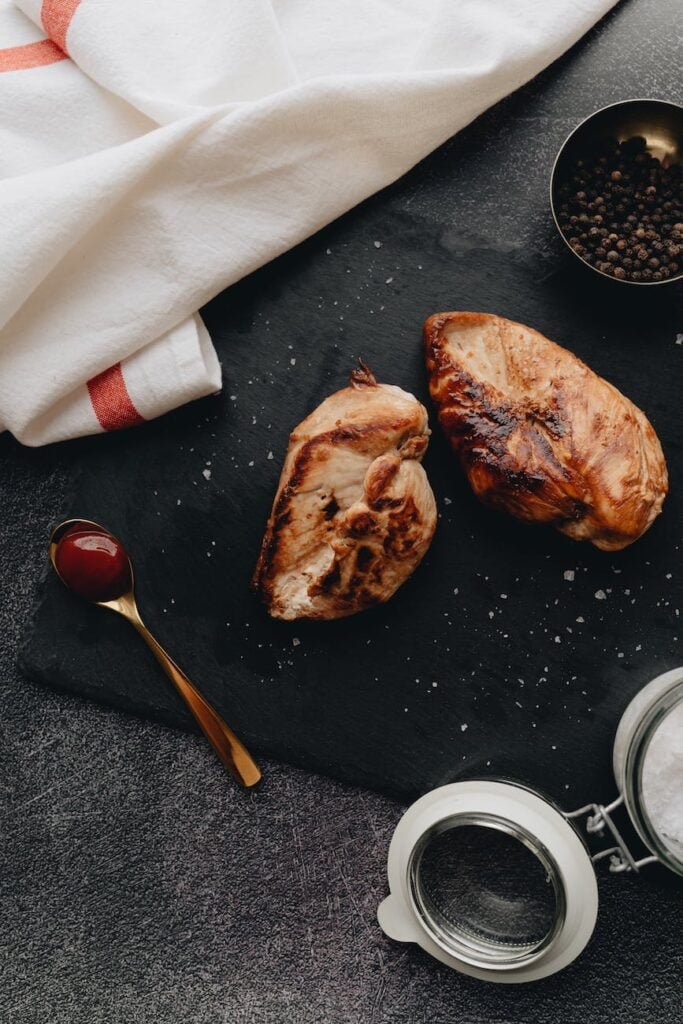 brown grilled meat on black slate