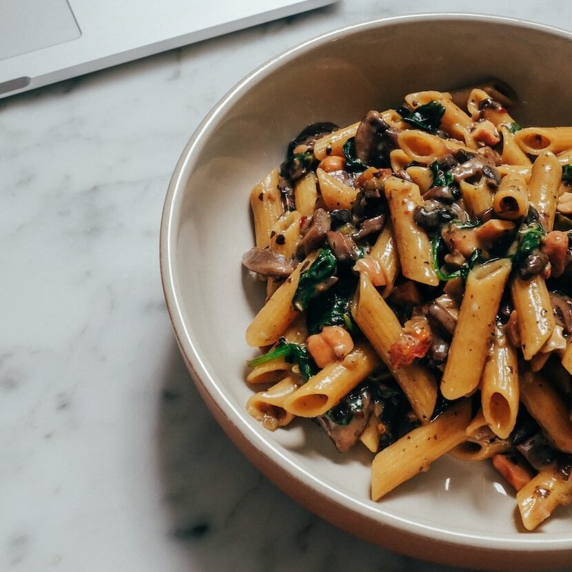 brown and green food in white ceramic bowl